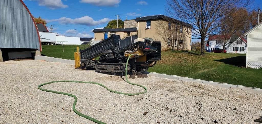 Directional drill set up for a utility bore beside a home